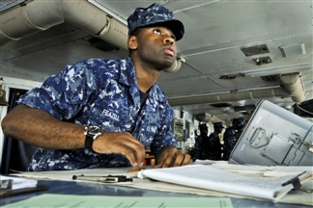 U.S. Navy Seaman Roosevelt Feazell charts a course from the bridge of the aircraft carrier USS Abraham Lincoln in the U.S. 7th Fleet area of responsibility as part of a deployment to the western Pacific and Indian Oceans.  The carrier is en route to support coalition efforts in the U.S. 5th Fleet area of responsibility.  