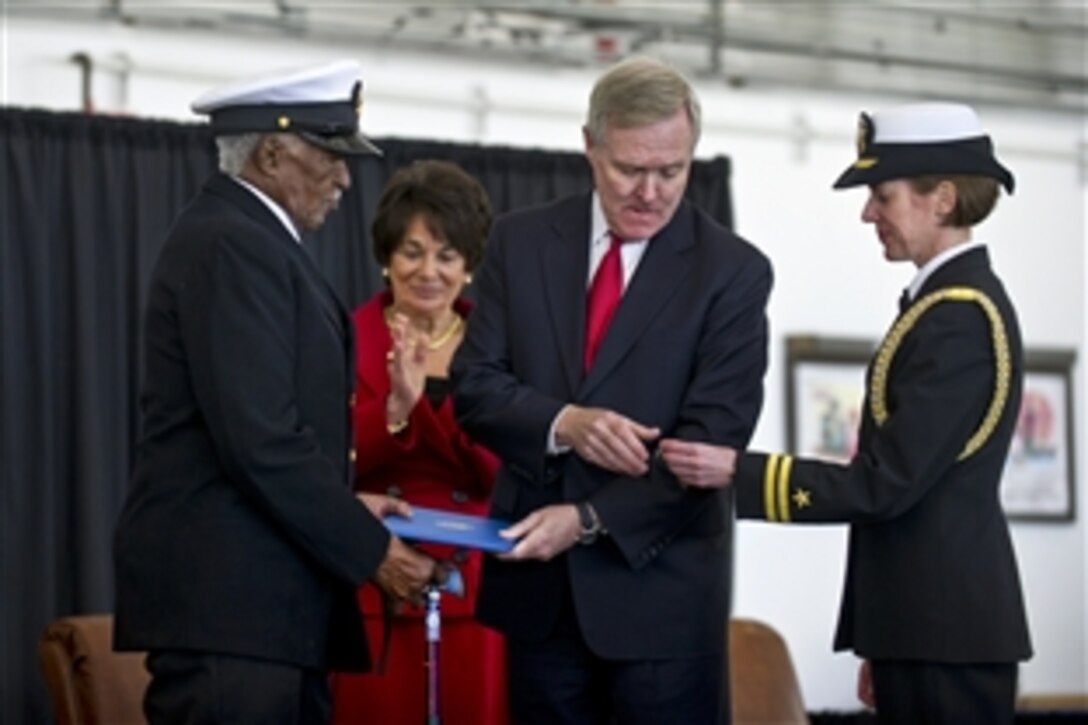 Navy Secretary Ray Mabus prepares to pin the Navy and Marine Corps Commendation Medal with a Combat Distinguishing Device on the chest of retired Navy Chief Petty Officer Carl E. Clark in Mountain View, Calif., Jan. 17, 2012. Mabus presented the medal to the 95-year-old Clark for his actions during World War II.
