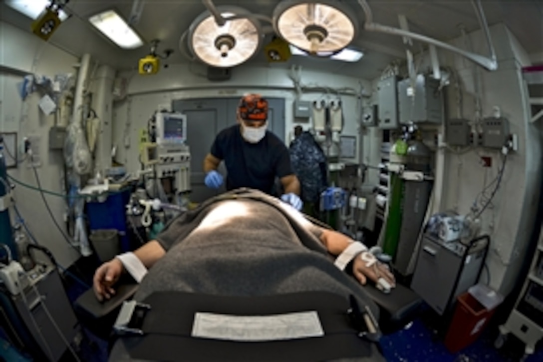 U.S. Navy Lt. Jacob Pletcher induces general anesthesia on a patient about to undergo surgery in the operating room of the aircraft carrier USS Abraham Lincoln in the Indian Ocean, Jan. 17, 2012. The Lincoln is in the U.S. 7th Fleet area of responsibility as part of a deployment to the western Pacific and Indian oceans.