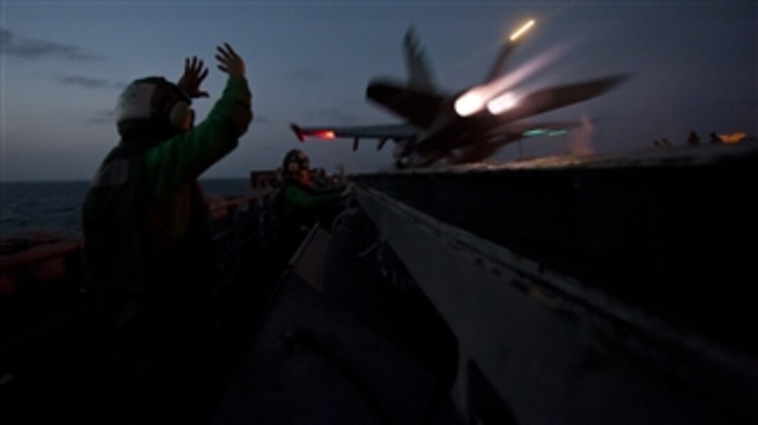 An F/A-18C Hornet aircraft attached to Strike Fighter Squadron 97 launches off the flight deck of the aircraft carrier USS John C. Stennis (CVN 74) while in the Arabian Sea on Jan. 15, 2012.  The John C. Stennis is deployed to the U.S. 5th Fleet area of responsibility conducting maritime security operations and support missions as part of Operation Enduring Freedom.  