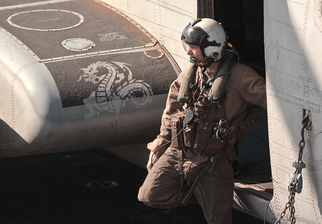 Crew chief Cpl. Michael C. Diegel prepares a CH-53E Super Stallion during flight operations aboard USS Makin Island here Jan. 19. Diegel serves with Marine Medium Helicopter Squadron 268 (Reinforced), the aviation combat element for the 11th Marine Expeditionary Unit. The unit is currently deployed aboard the amphibious assault ship as part of the Makin Island Amphibious Ready Group – a U.S. Central Command theater reserve force. The group is also providing support for maritime security operations and theater security cooperation efforts in the U.S. Navy's 5th Fleet area of responsibility.