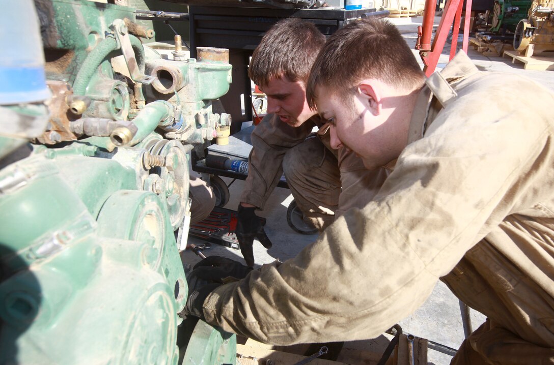British Army soldiers Craftsman Adam Evans (foreground) and Lance Cpl. Craig Heaton troubleshoot a Detroit Diesel V6 Logistics Vehicle System truck engine at the Intermediate Maintenance Activity lot aboard Camp Leatherneck, Afghanistan, Jan. 20. The pair is part of an ongoing exchange program between Marine Air-Ground Task Force Support Battalion 11.2’s Maintenance Company and their coalition counterparts at Camp Bastion. (U.S. Marine Corps photo by Sgt. Justin J. Shemanski)