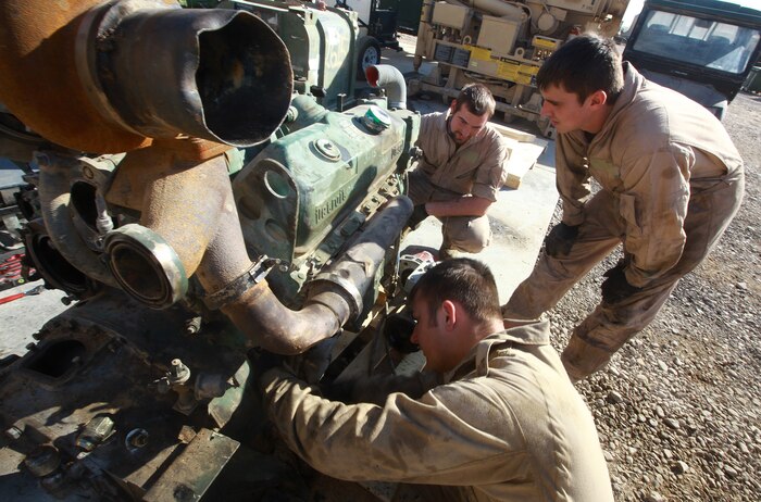 British Army soldiers Craftsman Adam Evans (foreground) and Lance Cpl. Craig Heaton (right) troubleshoot a Detroit Diesel V6 Logistics Vehicle System truck engine at the Intermediate Maintenance Activity lot aboard Camp Leatherneck, Afghanistan, Jan. 20. The pair is part of an ongoing exchange program between Marine Air-Ground Task Force Support Battalion 11.2's Maintenance Company and their coalition counterparts at Camp Bastion. (U.S. Marine Corps photo by Sgt. Justin J. Shemanski)