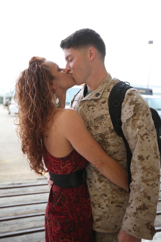 Sgt. Korey Norman, ordnance Marine with Marine Heavy Helicopter Squadron 366, and his wife, Jo Norman, share a much awaited kiss after an eight-month deployment to Djibouti with HMH-366 Jan. 20. In order to not miss Christmas together, Jo decorated the Norman residence with a Christmas tree and stockings in January to celebrate a late Christmas with Korey once he came home.