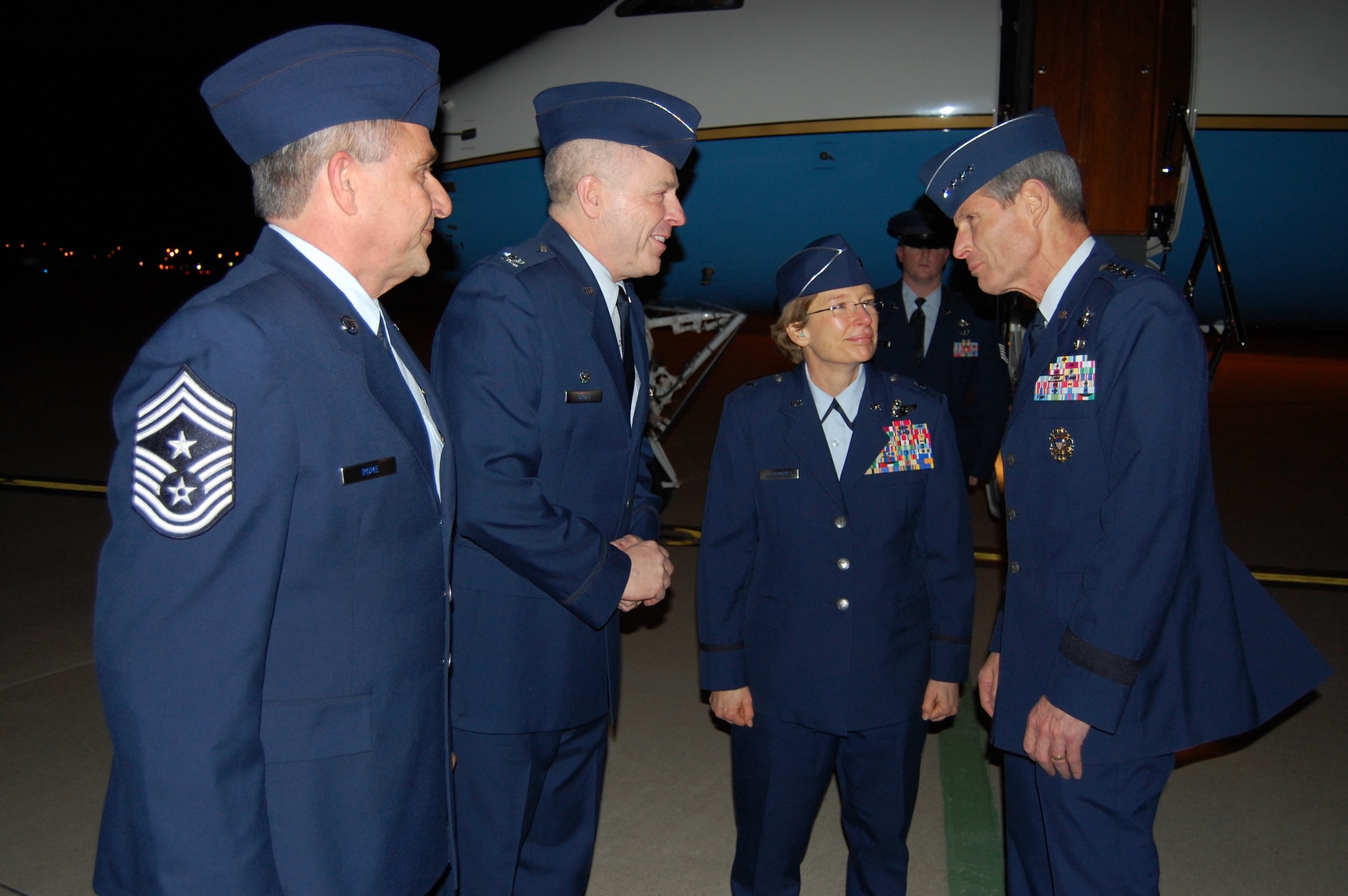 Air Force Chief of Staff Gen. Norton Schwartz speaks with Brig. Gen. Carol Timmons, Assistant Adjutant General for Air, Delaware National Guard, 166th Airlift Wing Commander Col. Jonathan Groff, Delaware Air National Guard, and 166th AW Command Chief Master Sgt. Henry Rome after Gen. Schwartz arrives at the New Castle ANG Base, New Castle, Del., the evening of Jan. 19, 2012. (U.S. Air Force photo/Tech. Sgt. Benjamin Matwey) 