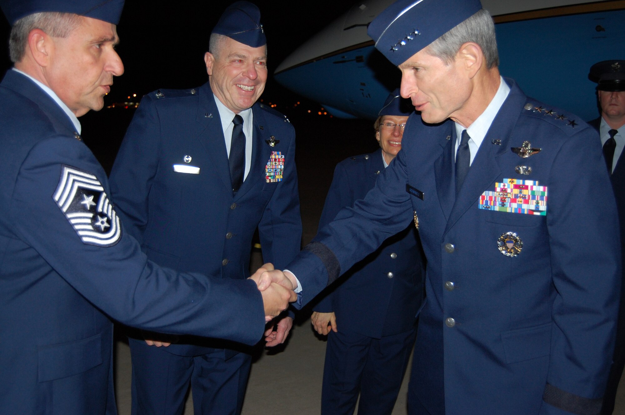 Air Force Chief of Staff Gen. Norton Schwartz exchanges a handshake with 166th Airlift Wing Command Chief Master Sgt. Henry Rome, Delaware Air National Guard, after Gen. Schwartz arrives at the New Castle ANG Base, New Castle, Del., the evening of Jan. 19, 2012. Brig. Gen. Carol Timmons, Assistant Adjutant General for Air, Delaware National Guard, and 166th AW Commander Col. Jonathan Groff, Delaware ANG, also greeted Gen. Schwartz. (U.S. Air Force photo/Tech. Sgt. Benjamin Matwey)