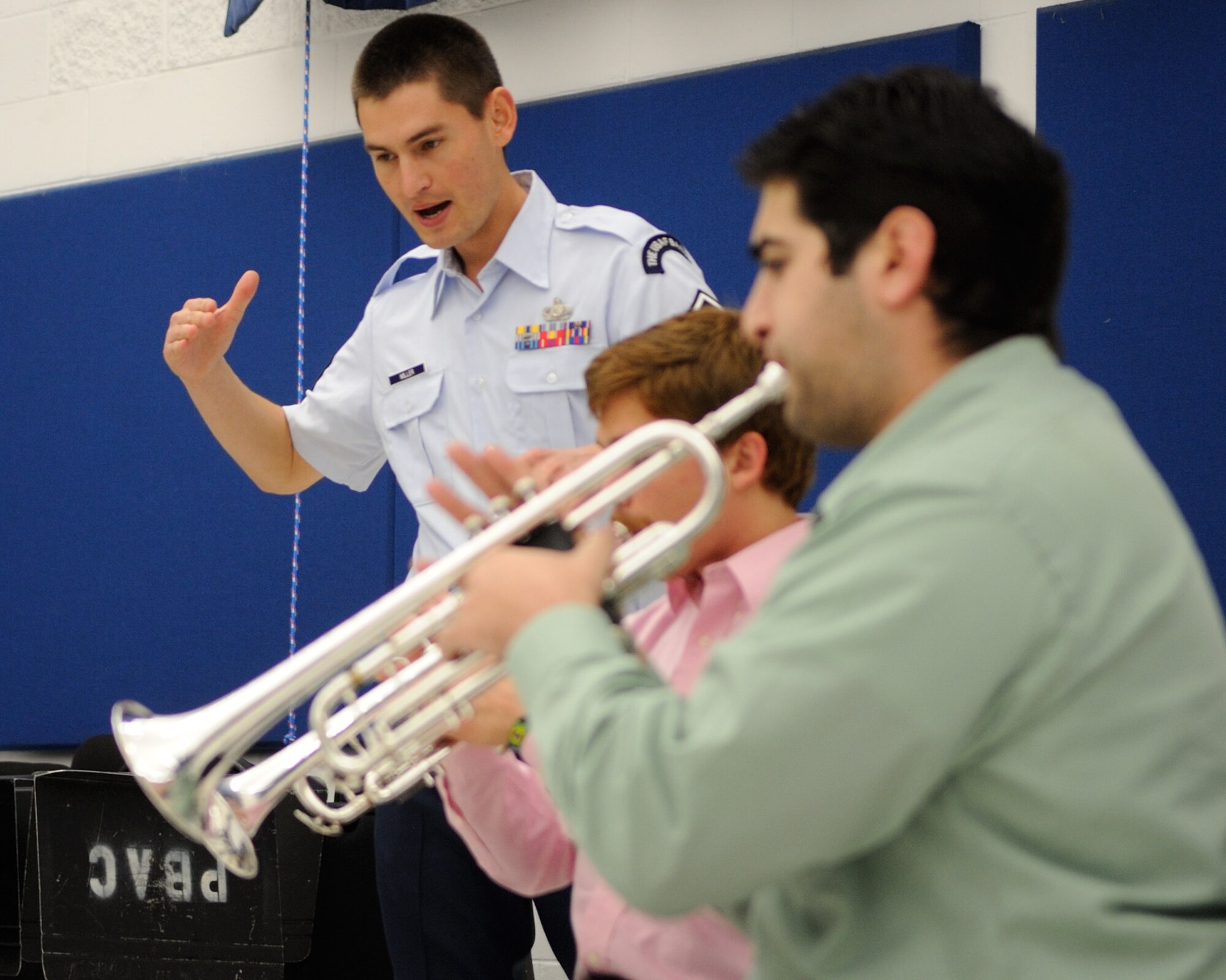 U.S. Air Force Master Sgt. Brett Miller, a French hornist with the U.S. Air Force Band Ceremonial Brass Quintet and a Boardman, Ohio, native, works with students from a brass quintet during a clinic at Palm Beach Atlantic University in West Palm Beach, Fla., Jan. 20, 2012.  The clinic involved the members of the Ceremonial Brass Quintet playing five pieces for the students, answering questions, and then working with the university's brass quintet to improve their playing style.  U.S. Air Force photo by Master Sgt. Adam M. Stump/RELEASED.