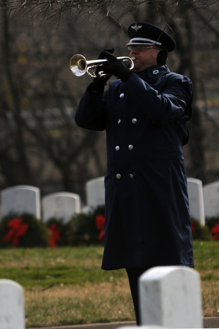A U.S. Air Force Band bugler plays taps during a burial ceremony for retired Lt. Col. Luke Weathers Jr. Jan. 20, 2012, at Arlington National Cemetery in Virginia. Weathers was an original Tuskegee Airman and pilot with the 302nd Fighter Squadron. (U.S. Air Force photo/Tech. Sgt. Mareshah Haynes)