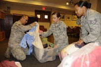 (from l-r) Staff Sgts Victor Pulido, Melanie Wester and Natca Moye of Joint Base San Antonio-Randolph Rising 5/6 count the amount of coats collected for “Cold Days, Warm Hearts,” during their meeting at the Parr Club, Jan 20. The goal was 50 coats but the organization far exceeded their goal by collecting 98 coats. 
(U.S. Air Force photo by Airman 1st Class Airman Siekert)
