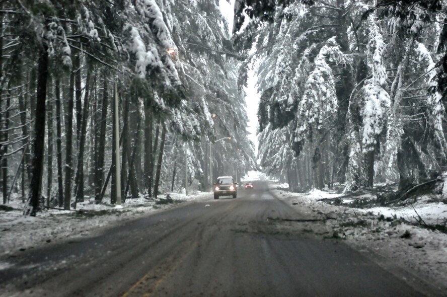 Drivers travel safely and slowly down Fairway Road which remains covered with debris after McChord Field experienced a winter storm which accumulated more than nine inches of snow Jan. 20, 2012, at Joint Base Lewis-McChord, Wash. (U.S. Air Force photo/Airman 1st Class Leah Young)