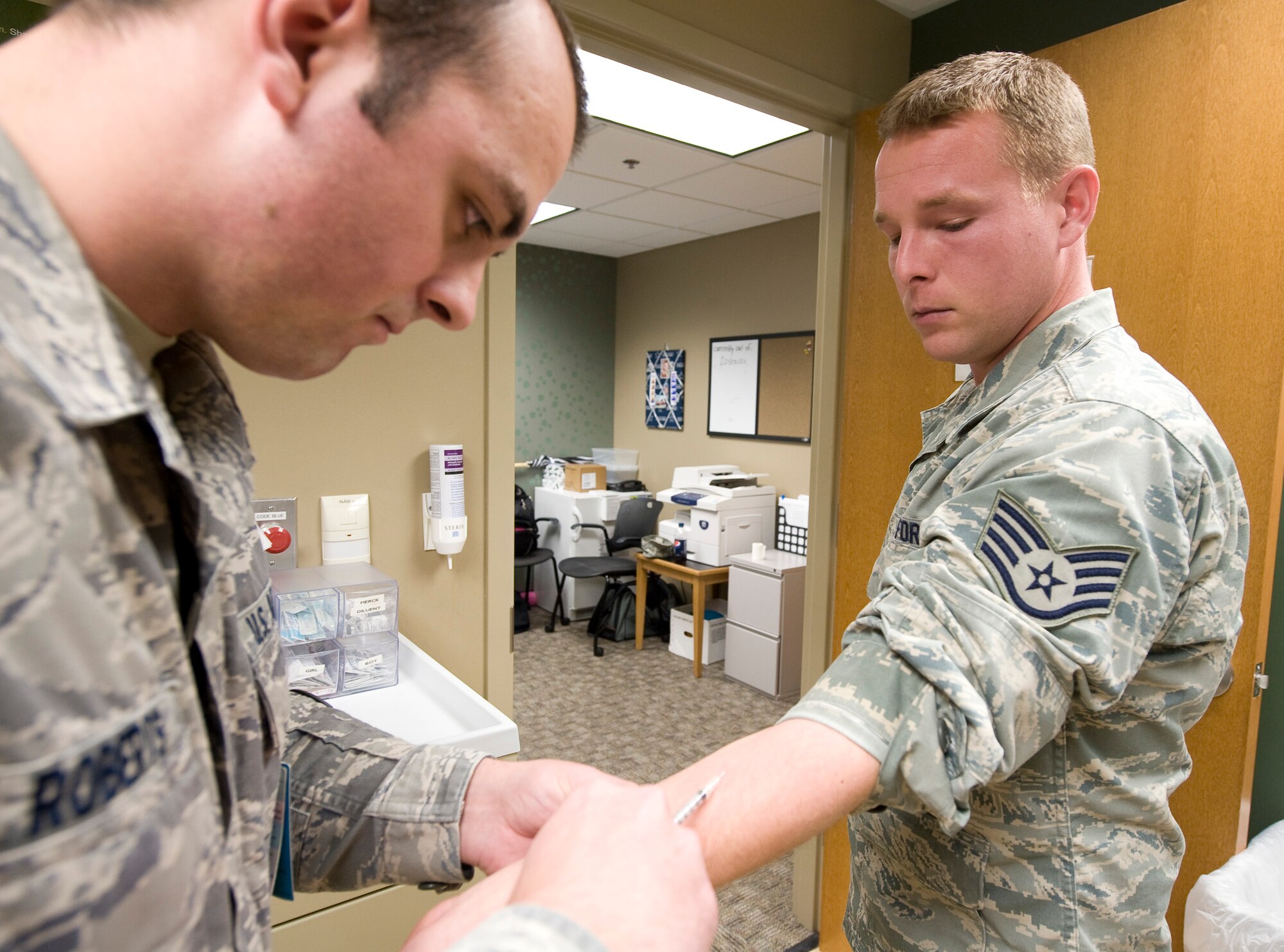 Senior Airman Alexander Roberts, 2nd Medical Group, administers an injection to Staff Sgt. Brandon Henry, 2nd Munitions Squadron, in the immunizations clinic on Barksdale Air Force Base, La., Jan. 18. The clinic provides a wide variety of vaccinations, as well as copies of shot records for Barksdale Airmen and their dependents.  (U.S. Air Force photo/Senior Airman Chad Warren)(RELEASED)
