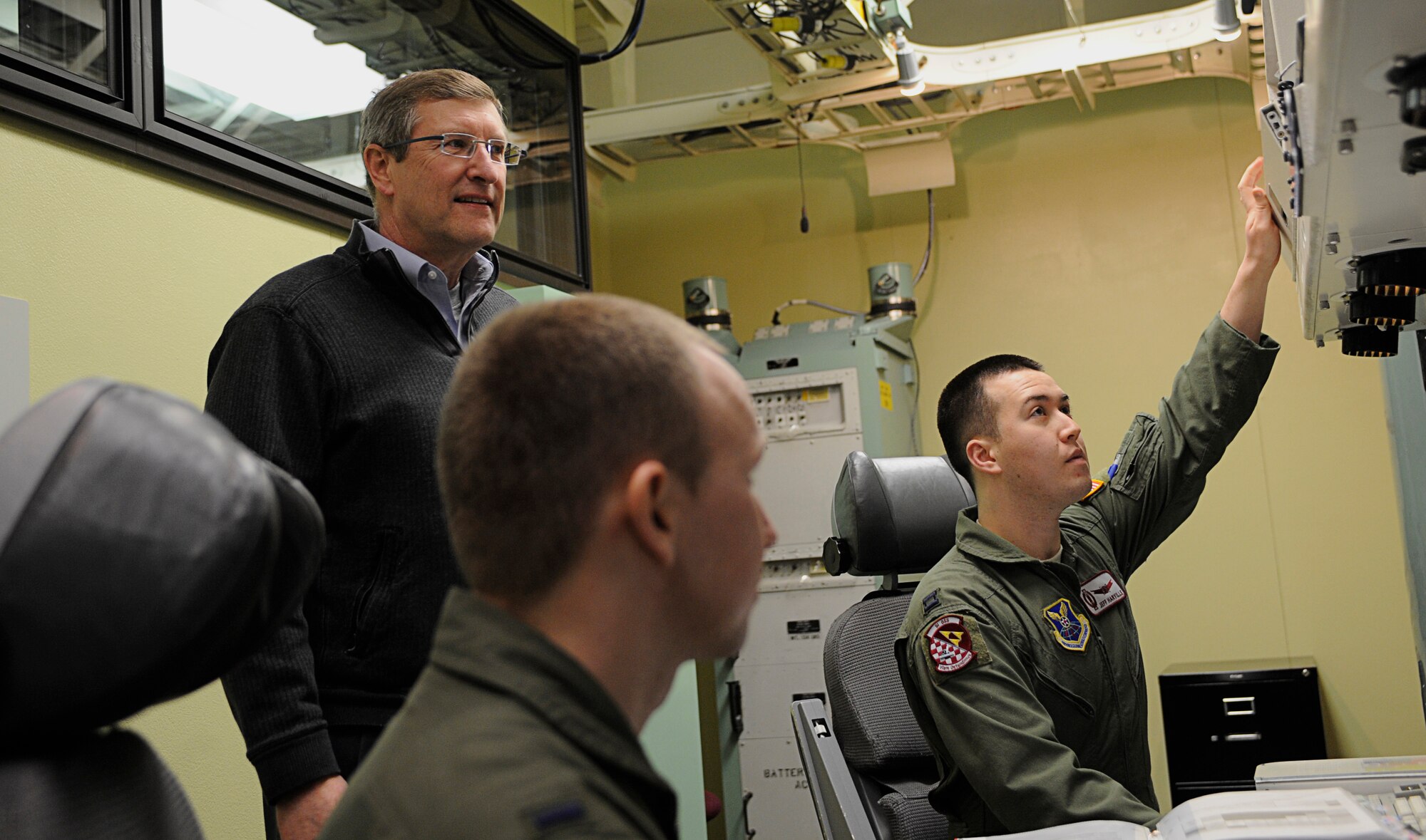 MINOT AIRFORCE BASE, N.D -- North Dakota Sen. Kent Conrad observes Capt. Jeffery Harville and 1st Lt. Michael Case, 91st Operations Support Squadron intercontinental ballistic missile combat crew members, during an emergency action procedure in response to a simulated nuclear attack here Jan. 19. The senator visited the base to take part in a tour of the 91st MW's newest military construction project, the Missile Operations Building, which was recently unveiled. (U.S. Air Force photo/Senior Airman Desiree W. Esposito)