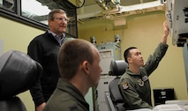 MINOT AIRFORCE BASE, N.D -- North Dakota Sen. Kent Conrad observes Capt. Jeffery Harville and 1st Lt. Michael Case, 91st Operations Support Squadron intercontinental ballistic missile combat crew members, during an emergency action procedure in response to a simulated nuclear attack here Jan. 19. The senator visited the base to take part in a tour of the 91st MW's newest military construction project, the Missile Operations Building, which was recently unveiled. (U.S. Air Force photo/Senior Airman Desiree W. Esposito)