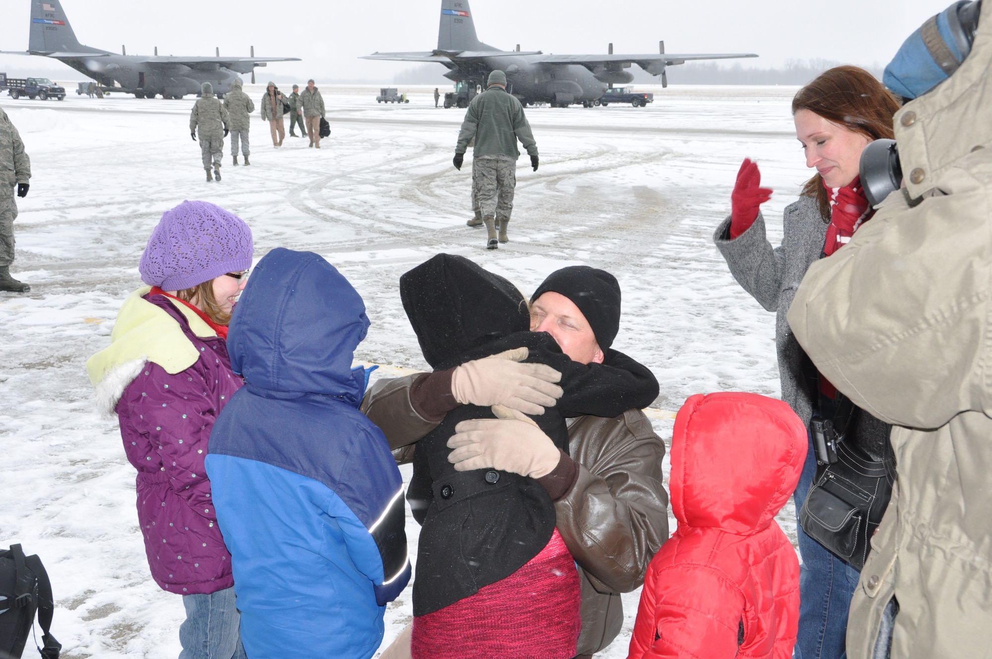 YOUNGSTOWN AIR RESERVE STATION, Ohio – Air Force Reserve Staff Sgt. Christopher O’Neill, a loadmaster assigned to the 773rd Airlift Squadron, is greeted by his children and his wife, Amy as he arrives on the flightline here, Jan. 19, 2012. O’Neill is one of approximately 40 Citizen Airmen that are the last of more than 140 Air Force Reservists, assigned to the 910th Airlift Wing’s flying and maintenance squadrons based at YARS, returning to Northeast Ohio after a 120-day deployment to Southwest Asia that supported to airlift operations to various military installations throughout the U.S. Central Command (USCENTCOM) Area of Operations (AOR). U.S. Air Force photo by Master Sgt. Bob Barko Jr.