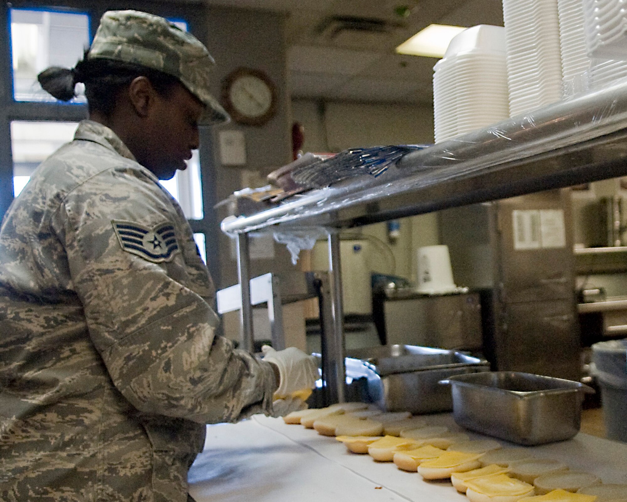 Staff Sgt. Jessica Becton, 2nd Force Support Squadron, prepares cheeseburgers for lunch at the Touch-n-Go Flight Kitchen on Barksdale Air Force Base, La., Jan. 18.  The flight kitchen is a smaller version of the Red River Dining Facility used to accommodate Airmen on the go. (U.S. Air Force photo/Senior Airman Kristin High)(RELEASED)