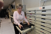 Silvia Ferrell, 902nd Communications Squadron client support center, puts a laptop computer in secure storage at the 902nd CS on Joint Base San Antonio-Randolph Jan. 18. 902nd CS is JBSA-Randolph's first line of defense against cyber attacks. (U.S. Air Force photo/Rich McFadden) (released)
