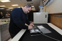 Marcus Hughes, 902nd Communications Squadron information protection officer, works on a hard disk drive assembly at the 902nd Communications Squadron on Joint Base San Antonio-Randolph Jan. 18. 902nd CS is JBSA-Randolph's first line of defense against cyber attacks. (U.S. Air Force photo/Rich McFadden) (released)