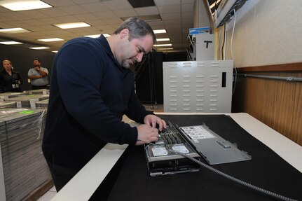 Marcus Hughes, 902nd Communications Squadron information protection officer, works on a hard disk drive assembly at the 902nd Communications Squadron on Joint Base San Antonio-Randolph Jan. 18. 902nd CS is JBSA-Randolph's first line of defense against cyber attacks. (U.S. Air Force photo/Rich McFadden) (released)