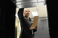 Shana Smith, 902nd Communications Squadron information protection officer, checks a mainframe computer for vulnerabilities at the 902nd Communications Squadron on Joint Base San Antonio-Randolph Jan. 18. 902nd CS is JBSA-Randolph's first line of defense against cyber attacks. (U.S. Air Force photo/Rich McFadden) (released)