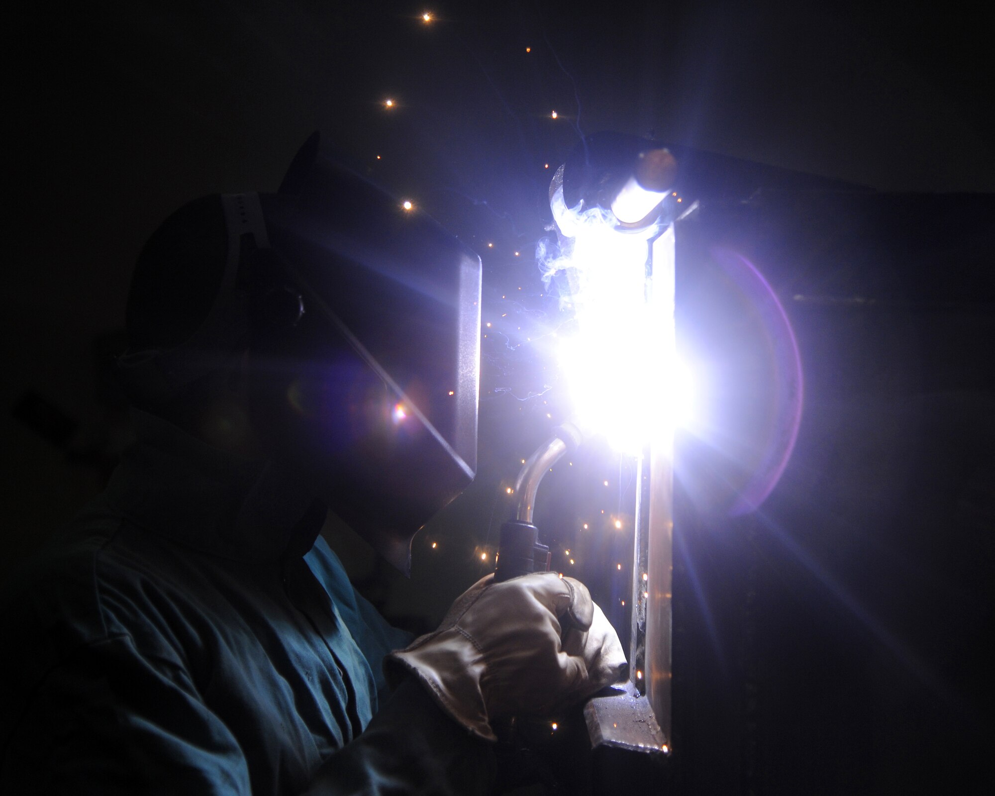 U.S. Air Force Airman 1st Class William Fox welds a hinge onto an ash box
Jan. 18, 2012, Eielson Air Force Base, Alaska. The ash box will be used to store
ash during transport from Eielson's power plant to the ash disposal site.
Fox is assigned to the 354th Civil Engineer Squadron. (U.S. Air Force photo
by Senior Airman Willard E. Grande II/Released)
