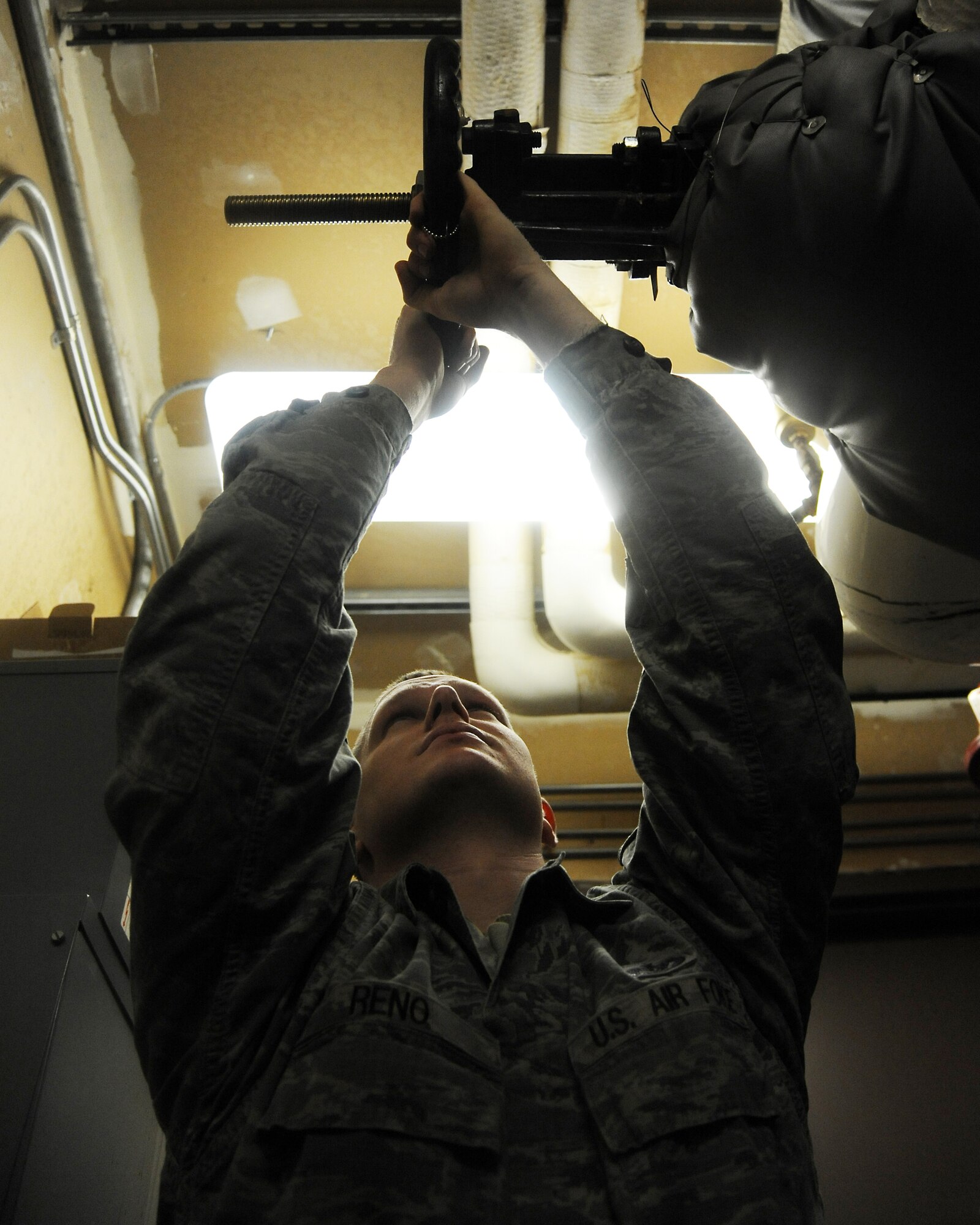 U.S. Air Force Staff Sgt. Travis Reno closes a valve on a return heating line to perform preventative maintenance Jan. 18, 2012, Eielson Air Force Base, Alaska. The heating line circulates an antifreeze solution through heating systems to keep buildings warm. Reno is a heating, ventilation and air conditioning technician is assigned to the 354th Civil Engineer Squadron. (U.S. Air Force photo by Senior Airman Willard E. Grande II/Released)