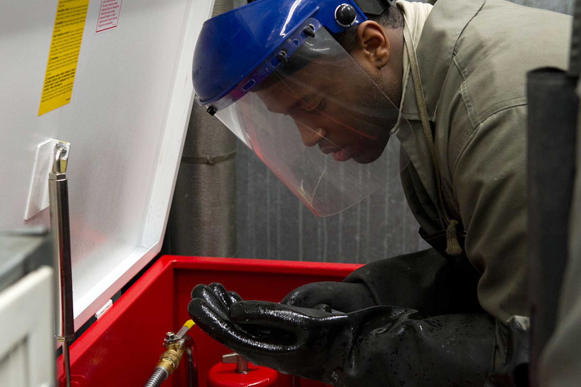 Airman 1st Class Dimitri Davis, Aerospace Ground Equipment apprentice, 3rd Maintenance Squadron, inspects a wheel bearing from a Trilectron on Joint Base Elmendorf-Richardson Jan. 11. Members of AGE handle generators, heaters, air conditioners, lights and other equipment used to support the aircraft or the people working on the aircraft. (U.S. Air Force photo/Staff Sgt. Zachary Wolf)