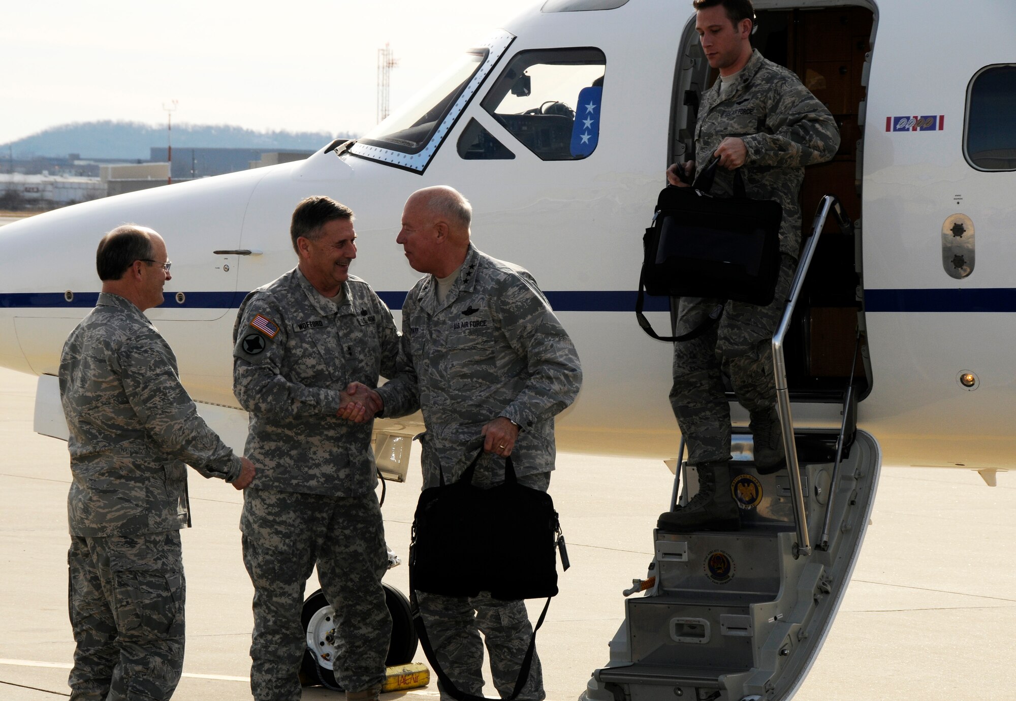 Lt. Gen. Harry M. Wyatt III, Director of the Air National Guard, middle, shakes hands with Maj. Gen. William Wofford, Arkansas National Guard adjutant general, as Brig. Gen. Dwight Balch, Arkansas Air National Guard commander, left, looks on. Wyatt visited the 188th Fighter Wing Jan. 18 and met with 188th leaders and officials with the City of Fort Smith. Wyatt also was able to gauge the 188th’s capabilities and assets during a helicopter flight over Ebbing Air National Guard Base and Fort Chaffee Maneuver Training Center, where the 188th’s Detachment 1 Razorback Range is located. Wyatt was able to observe an exercise at Razorback Range involving the 188th’s A-10C Thunderbolt II “Warthogs” and the 188th Security Forces Squadron. (National Guard photo by Tech Sgt. Josh Jones/188th Fighter Wing Public Affairs)