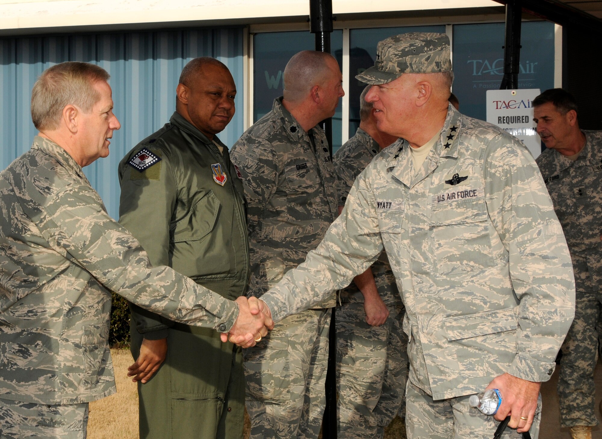 Lt. Gen. Harry M. Wyatt III, Director of the Air National Guard, right, shakes hands with Col. Mark Berry, 188th Maintenance Group commander, as Lt. Col. Tim Eddins, 188th Operations Group commander, looks on. Wyatt visited the 188th Jan. 18 and met with unit and Arkansas National Guard leaders as well as officials with the City of Fort Smith. Wyatt also was able to gauge the 188th’s capabilities and assets during a helicopter flight over Ebbing Air National Guard Base and Fort Chaffee Maneuver Training Center, where the 188th’s Detachment 1 Razorback Range is located. Wyatt was able to observe an exercise at Razorback Range involving the 188th’s A-10C Thunderbolt II “Warthogs” and the 188th Security Forces Squadron. (National Guard photo by Senior Master Sgt. Dennis Brambl/188th Fighter Wing Public Affairs)