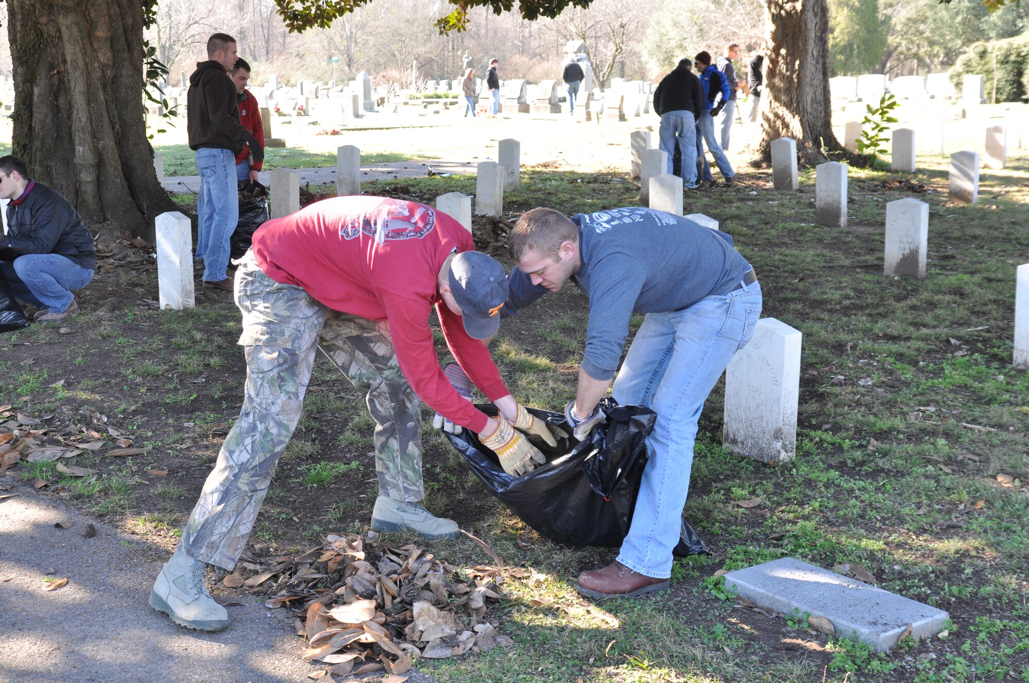 Specialized Undergraduate Pilot Training students work to clean up Friendship Cemetery Jan. 18 in downtown Columbus, Miss.  Friendship Cemetery was founded 163 years ago and is home to the remains of Capt. Sam Kaye, a local war hero with several memorials on Columbus Air Force Base. (U.S. Air Force photo/Airman 1st Class Charles Dickens)