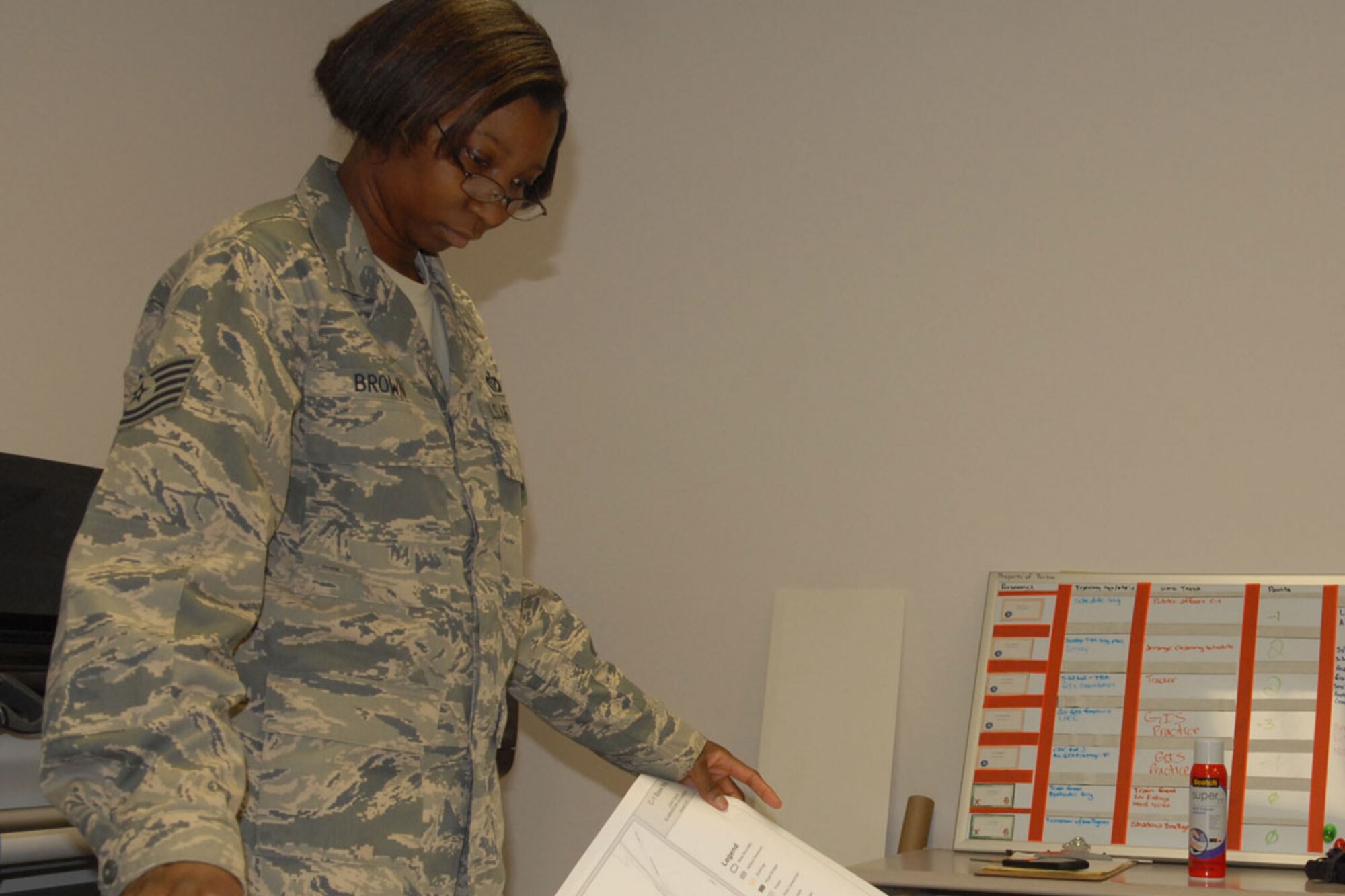 Tech. Sgt. Yucari Brown, 673d Civil Engineering Squadron, examines a newly printed map at Joint Base Elmendorf-Richardson’s geobase shop Jan. 11. Brown was promoted to technical sergeant Dec. 9 through Stripes Through Exceptional Performance program. (U.S. Air Force photo/Senior Airman Blake Mize) 
