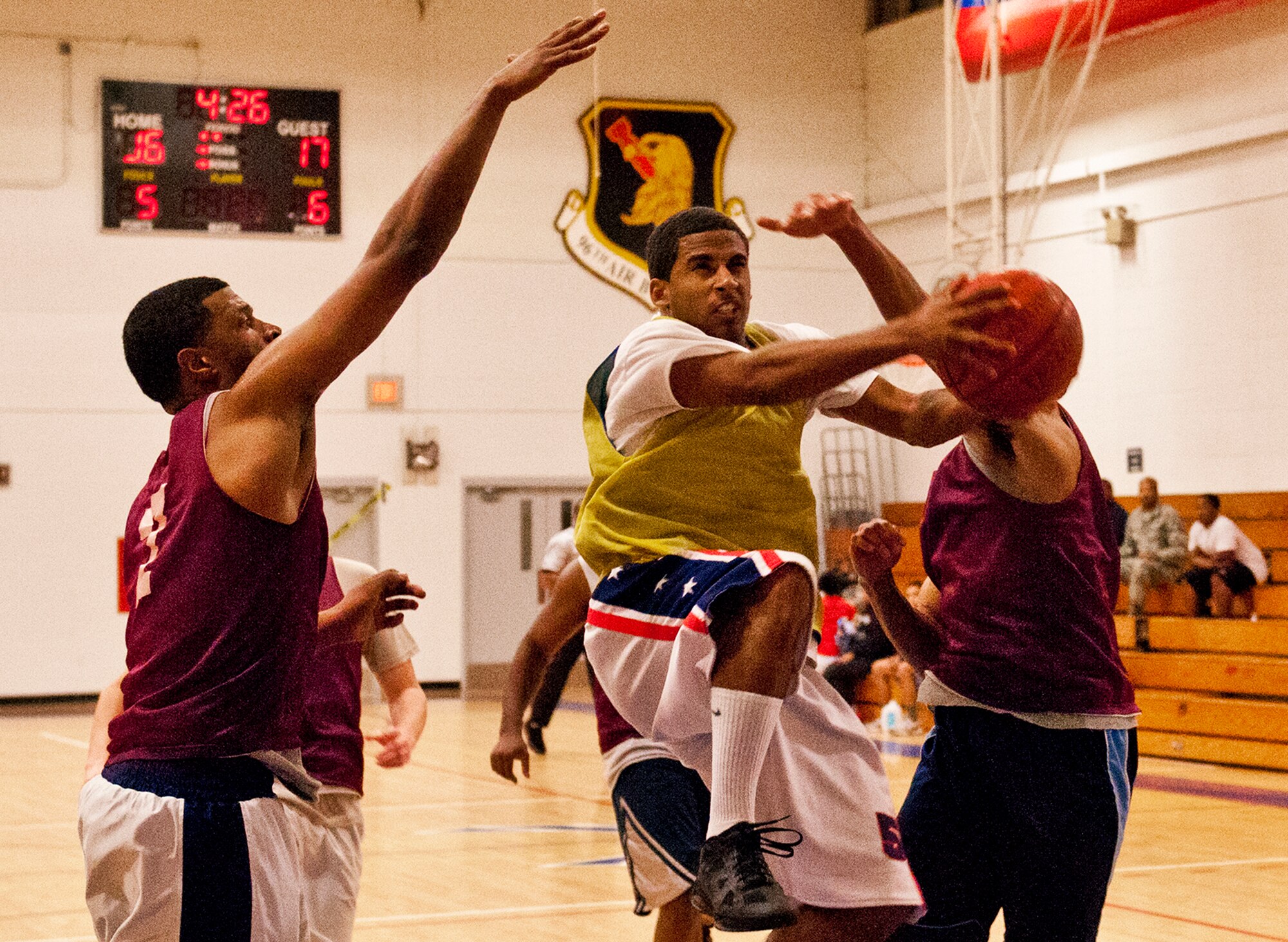 Drevell Herron, of the 96th Force Support Squadron team, splits two 96th Logistics Readiness Squadron defenders on the way to the basket during the base intramural championship game at Eglin Air Force Base, Fla., Jan. 19.  FSS defeated the defending champion LRS team 54-45 in a close game.  FSS’s explosion of points in the final four minutes sealed the game.  (U.S. Air Force photo/Samuel King Jr.)