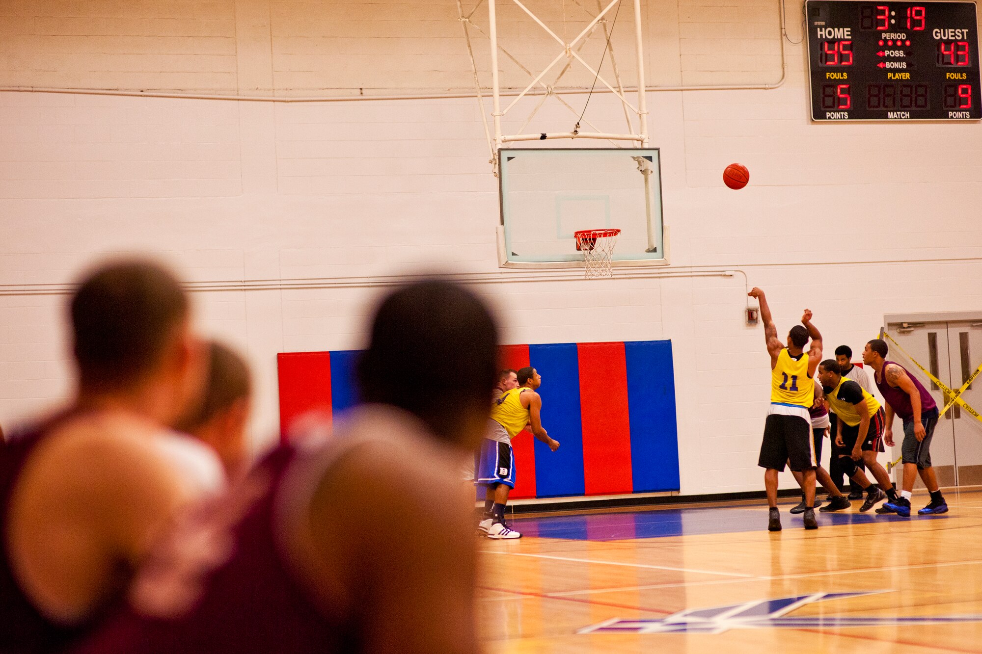 Players from the 96th Logistics Readiness Squadron team watch as Tommie Taylor, of the 96th Force Support Squadron team, takes a foul shot in the final three minutes of the base intramural championship game at Eglin Air Force Base, Fla., Jan. 19.  FSS defeated the defending champion LRS team 54-45 in a close game.  FSS’s explosion of points in the final four minutes sealed the game.  (U.S. Air Force photo/Samuel King Jr.)