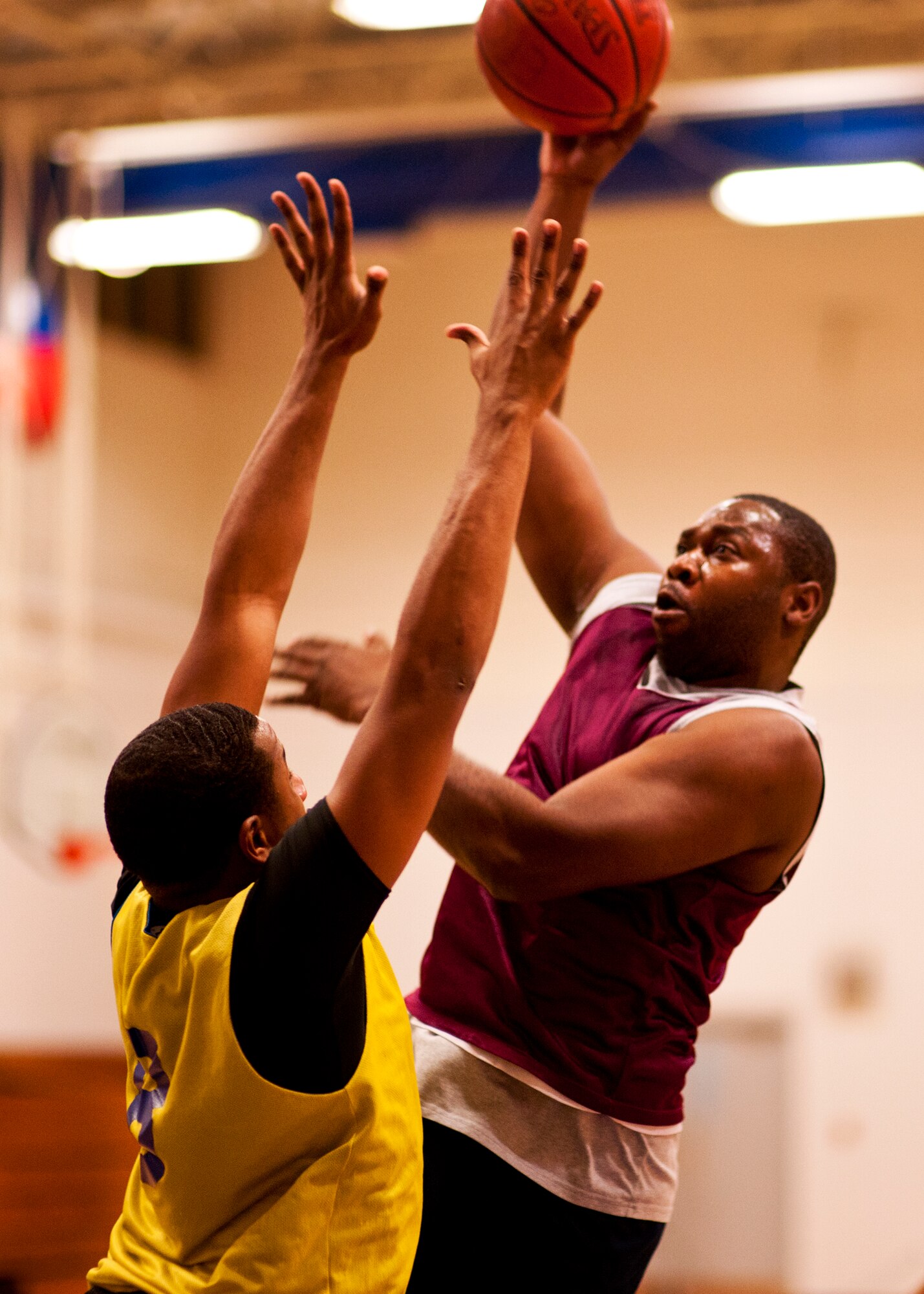 Choy Alexander, of the 96th Logistics Readiness Squadron team, shoots over a 96th Force Support Squadron defender during the base intramural championship game at Eglin Air Force Base, Fla., Jan. 19.  FSS defeated the defending champion LRS team 54-45 in a close game.  FSS’s explosion of points in the final four minutes sealed the game.  (U.S. Air Force photo/Samuel King Jr.)