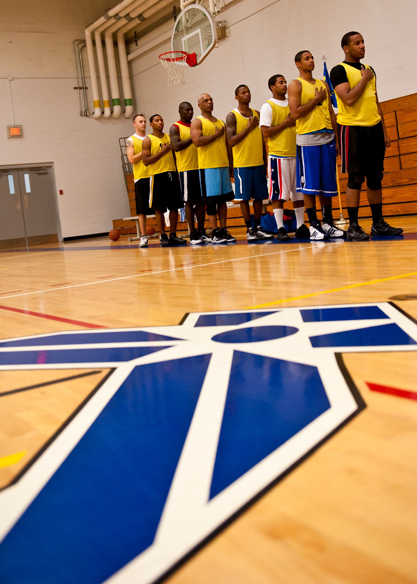 Players from the 96th Force Support Squadron team stand for the National Anthem during the base intramural basketball championship game against the 96th Logistics Readiness Squadron at Eglin Air Force Base, Fla., Jan. 19.  FSS defeated the defending champion LRS team 54-45 in a close game.  FSS’s explosion of points in the final four minutes sealed the game.  (U.S. Air Force photo/Samuel King Jr.)