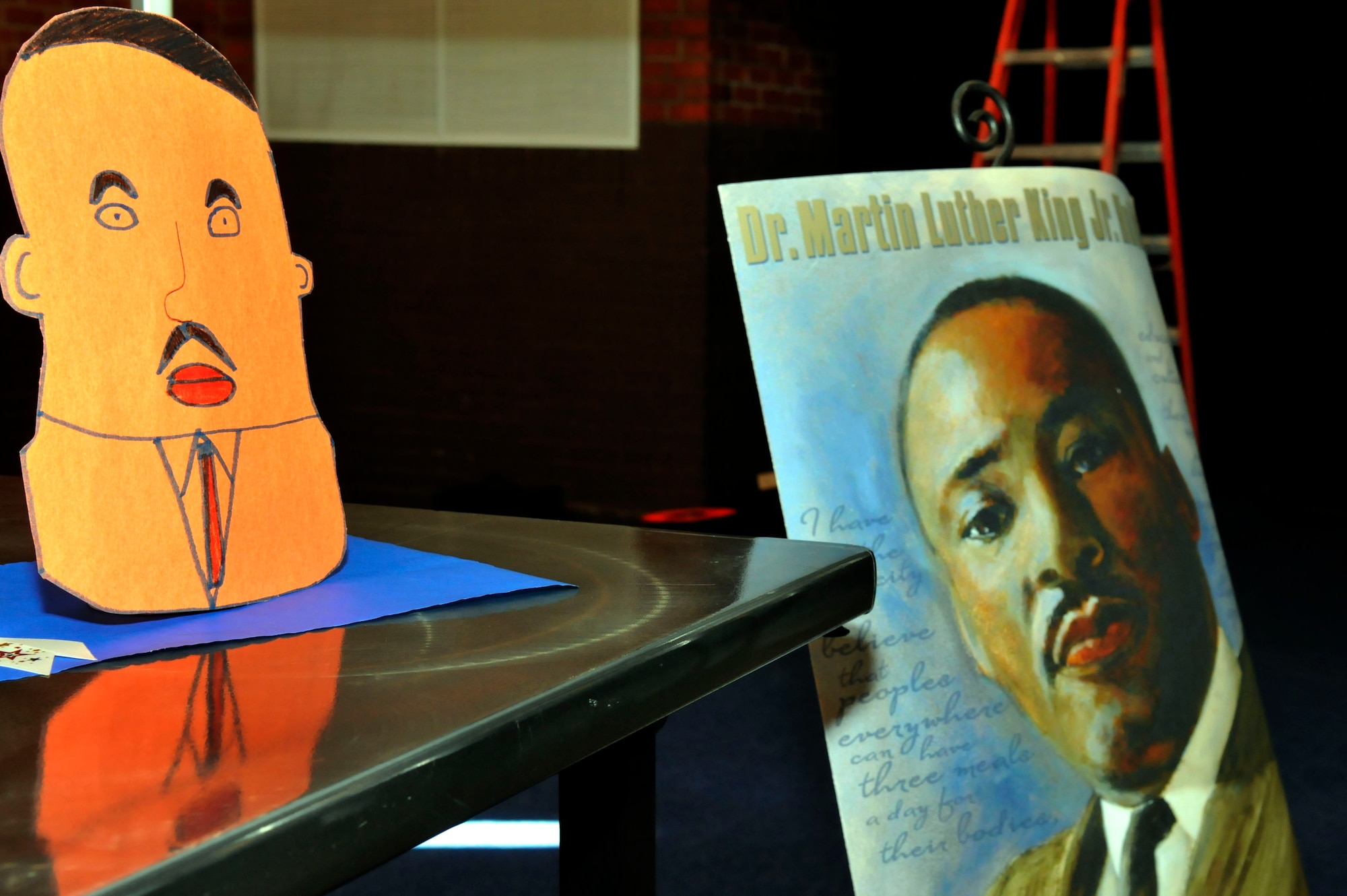 Art work made as part of a youth center program, alongside professional posters, decorates the Fall Hall Community Center during the Dr. Martin Luther King, Jr., Luncheon Jan. 13. (U.S. Air Force photo by R.J. Oriez)