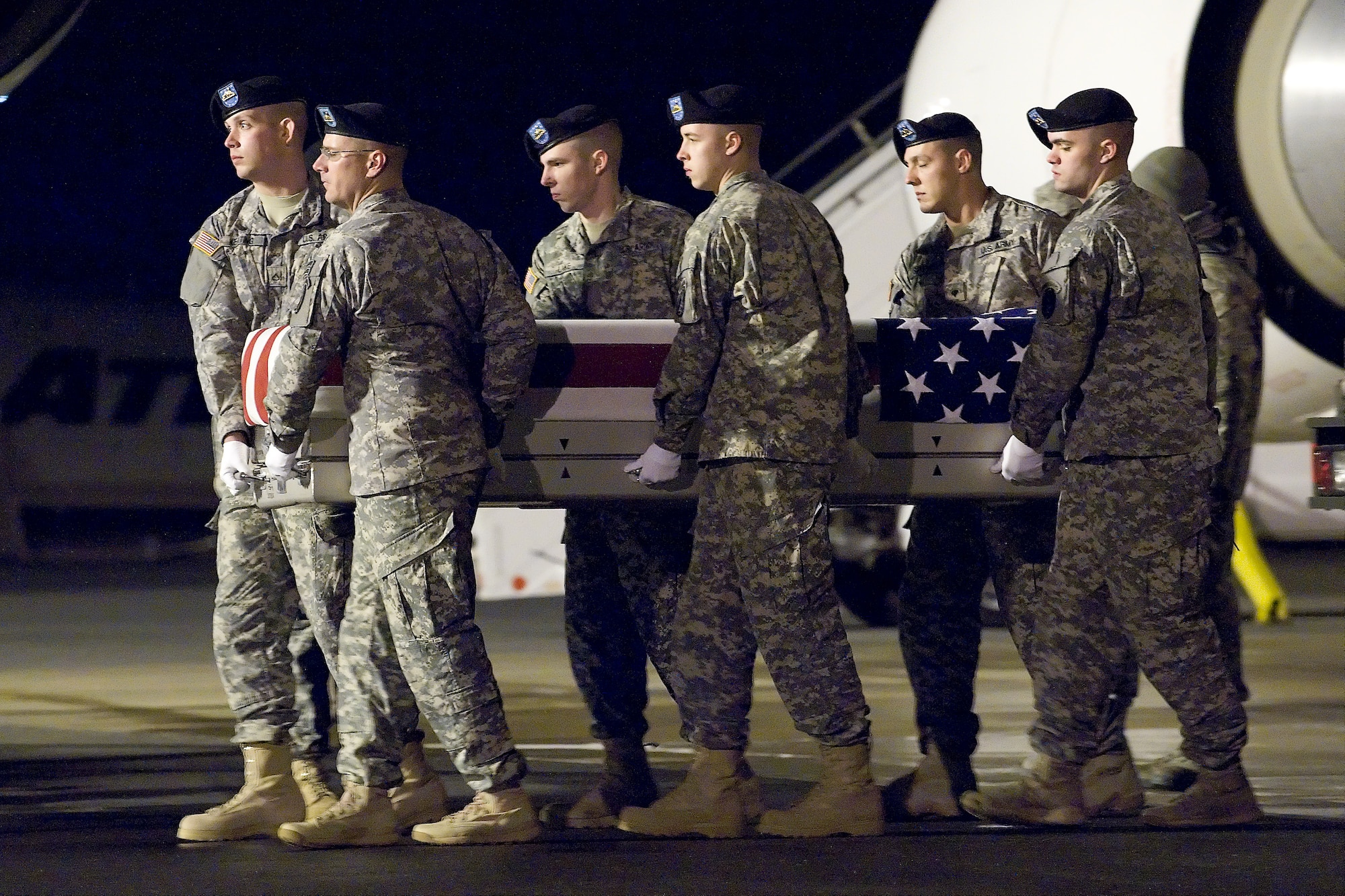 A U.S. Army carry team transfers the remains of Army Spc. Keith D. Benson, of Brockton, Mass., at Dover Air Force Base, Del., Jan. 19, 2012. Benson was assigned to the 2nd Battalion, 28th Infantry Regiment, 172nd Infantry Brigade, Grafenwoehr, Germany. (U.S. Air Force photo/Steve Kotecki)