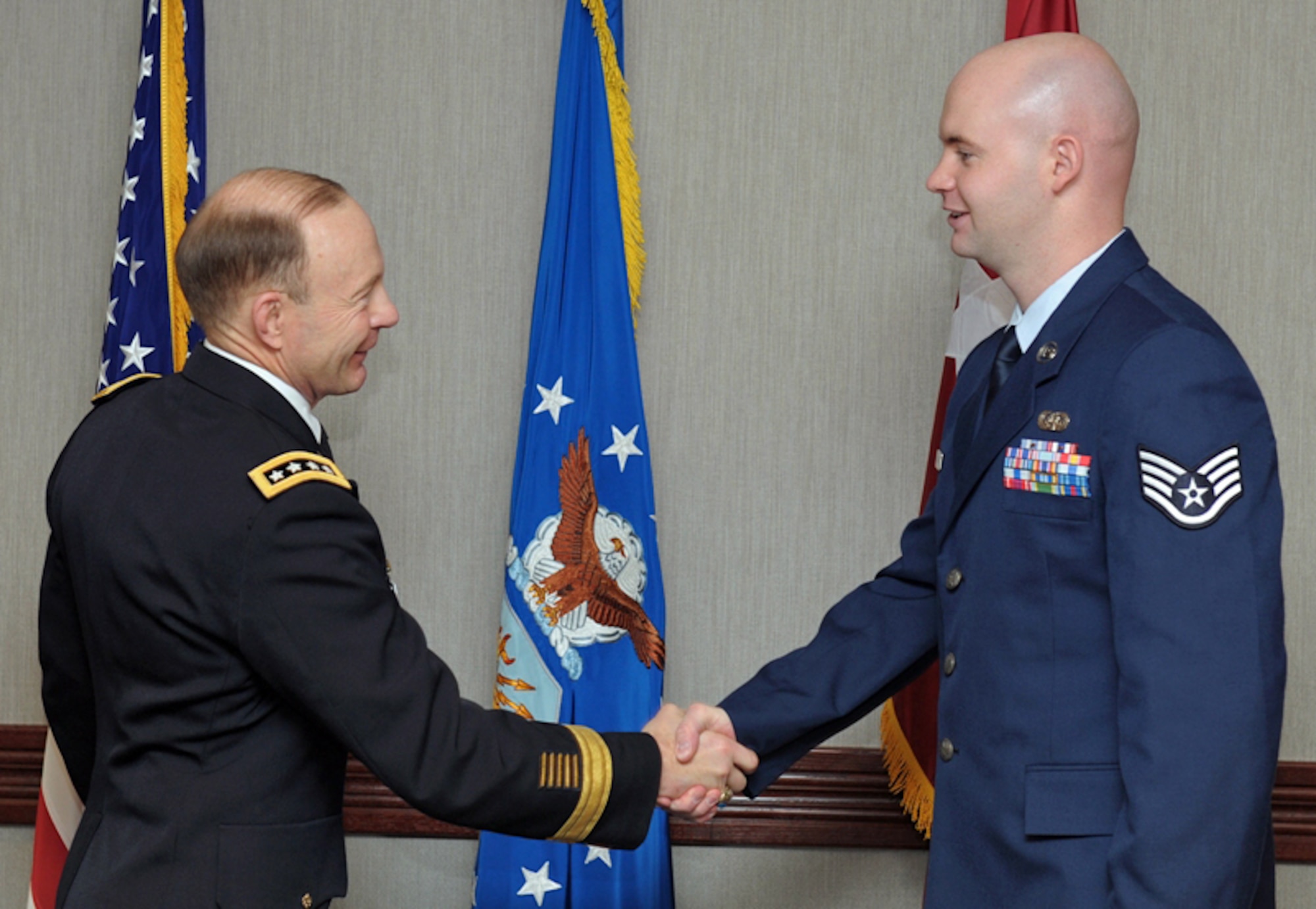 PETERSON AIR FORCE BASE, Colo. – U.S. Army Gen. Charles Jacoby Jr. (left), NORAD/USNORTHCOM commander, administers the oath of enlistment to Staff Sgt. Andrew Clark, 21st Communications Squadron, Dec. 15 in Building 2. Clark is a network maintenance technician and supports NORAD/USNORTHCOM, Air Force Space Command, and five geographically separated units by maintaining and troubleshooting secure communication service interruptions, and monitoring secure worldwide teleconferences. (U.S. Air Force photo)