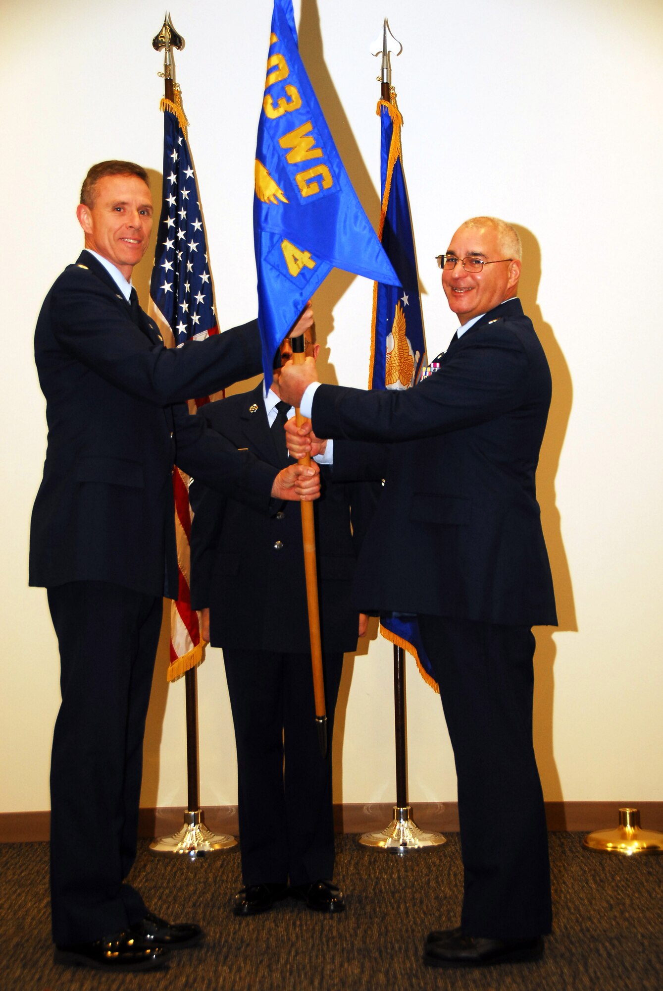 Lt. Col. Johnathan Wright accepts command of the 403rd Communications Flight from Lt. Col. Kevin Riley, 403rd Wing Mission Support Group commander, during the change of command ceremony Jan. 8. Wright comes to the 403rd from 22nd Air Force A-6. (U.S. Air Force photo by Staff Sgt. Tabitha Dupas) 

