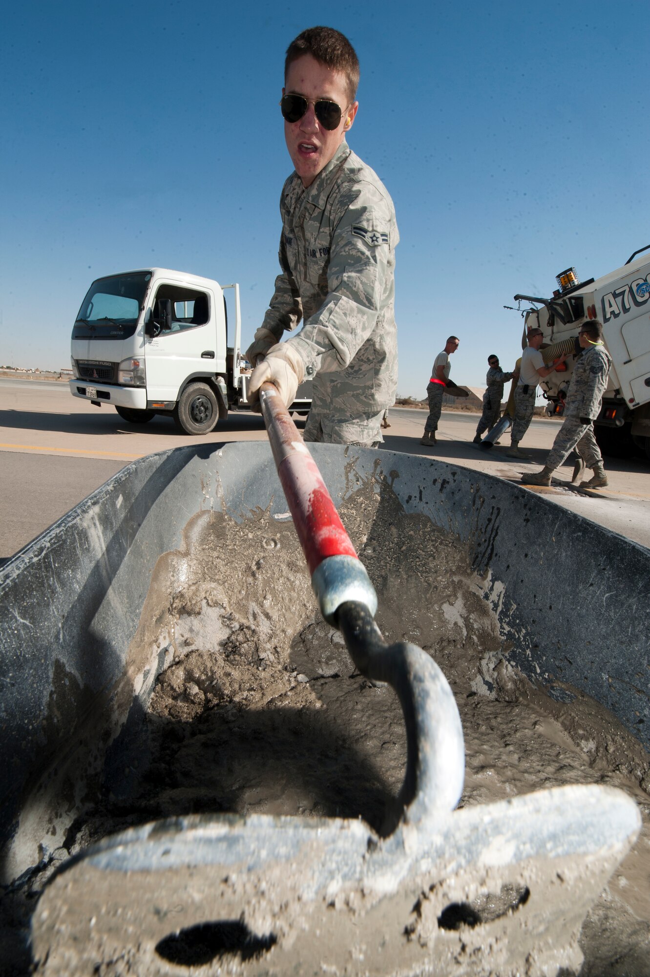 Airman 1st Class Derek Sizemore, 332nd Expeditionary Civil Engineer Squadron heavy equipment operator, mixes quick dry cement at an undisclosed location in Southwest Asia, Jan. 20, 2012. The cement, which took a couple of hours to dry, was used to repair damaged areas of the flightline. Sizemore is native to Hattiesburg, Miss. and is deployed from Whiteman Air Force Base, Mo. (U.S. Air Force photo by Staff Sgt. Joshua J. Garcia/Released)