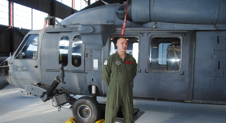 Tech. Sgt. Jason Davis, 512th Rescue Squadron HH-60G aerial gunner, stands in front of the aircraft used during a rescue operation Monday at White Sands National Monument.  U.S. Air Force Photo by Stefan Bocchino.