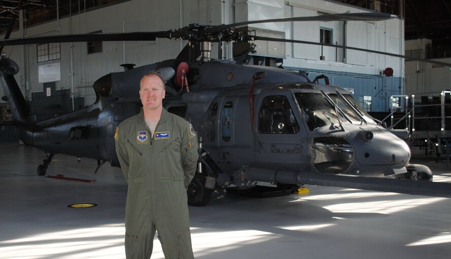 Maj. Adam Rudolphi, 58th Operations Support Squadron and pilot for the White Sands National Monument rescue mission, stands in front of the HH-60G used to rescue a teenager who became separated from his family Sunday.  U.S. Air Force Photo by Stefan Bocchino.