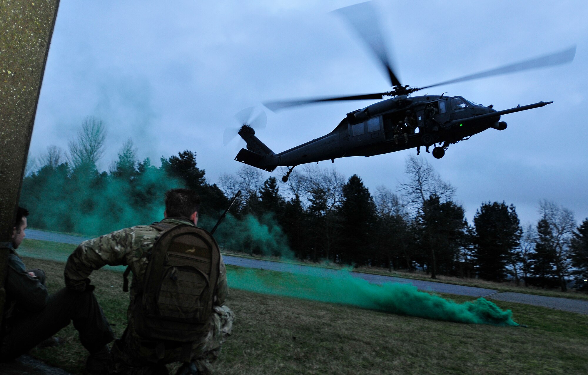 ROYAL AIR FORCE HONINGTON, England - Airmen stand by as a 56th Rescue Squadron HH-60G Pave Hawk prepares to land during a personnel recovery exercise, Jan. 18, 2012. The exercise exhibited the 56th RQS's capabilities to Gen. Mark A. Welsh III, U.S. Air Forces in Europe commander. Welsh, his wife Betty, Chief Master Sgt. David Williamson, USAFE command chief, and his wife Marie visited RAF Lakenheath to express their gratitude for the hard work and dedication of the Liberty warriors and to discuss upcoming changes in today's Air Force. (U.S. Air Force photo by Senior Airman Tiffany M. Deuel)