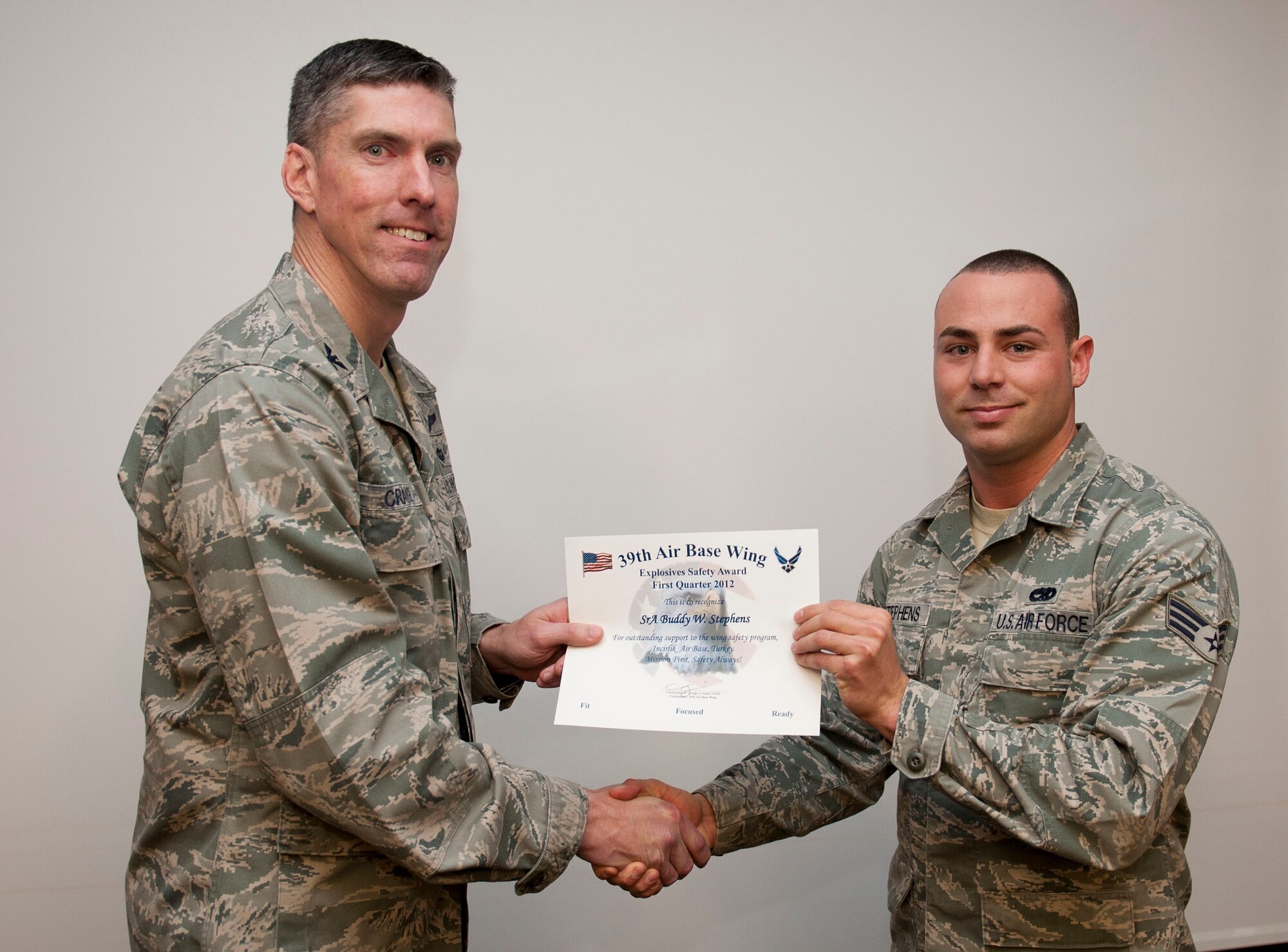 Senior Airman Buddy Stevens, 39th Maintenance Squadron munitions system journeyman, receives the Explosives Safety Award from Col. Chris Craige, 39th Air Base Wing commander, Jan. 19, 2012, at Incirlik Air Base, Turkey. Stevens earned the award by detecting and eliminating explosive hazards on 900 decoy flares. (U.S. Air Force photo by Senior Airman Clayton Lenhardt/Released)