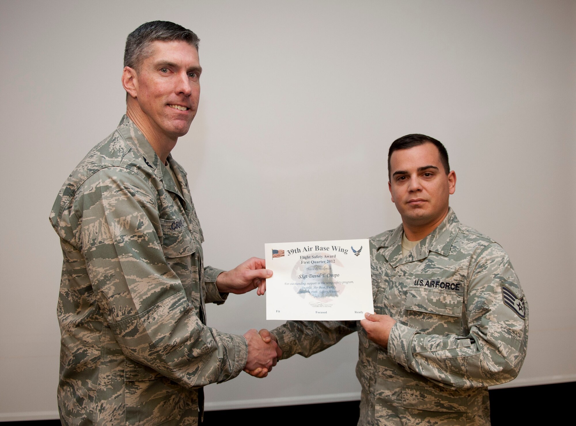 Staff Sgt. David Crespo, 39th Communications Squadron airfield systems journeyman, receives the Flight Safety Award from Col. Chris Craige, 39th Air Base Wing commander, Jan. 19, 2012, at Incirlik Air Base, Turkey. Crespo earned the award by supervising 100 navigational aid system inspections and correcting 25 discrepancies, as well as for achieving a 99.6 percent airfield operations rate, earning an excellent rating in the Air Traffic System Evaluation Program. (U.S. Air Force photo by Senior Airman Clayton Lenhardt/Released)