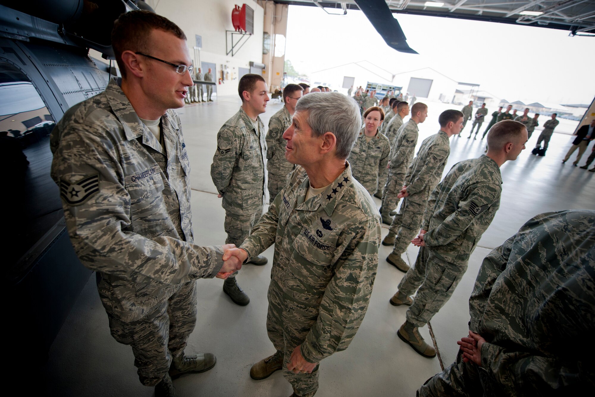 Air Force Chief of Staff Gen. Norton Schwartz shakes hands with U.S. Air Force Staff Sgt. Nick Chamberlain, 23d Aircraft Maintenance Squadron avionics systems craftsman, during a visit to Moody Air Force Base, Ga., Jan. 18, 2012. Schwartz met with Airmen from the 347th Rescue Group and 23d Maintenance, Fighter, Medical and Mission Support Groups. (U.S. Air Force photo by Staff Sgt. Jamal D. Sutter/Released)