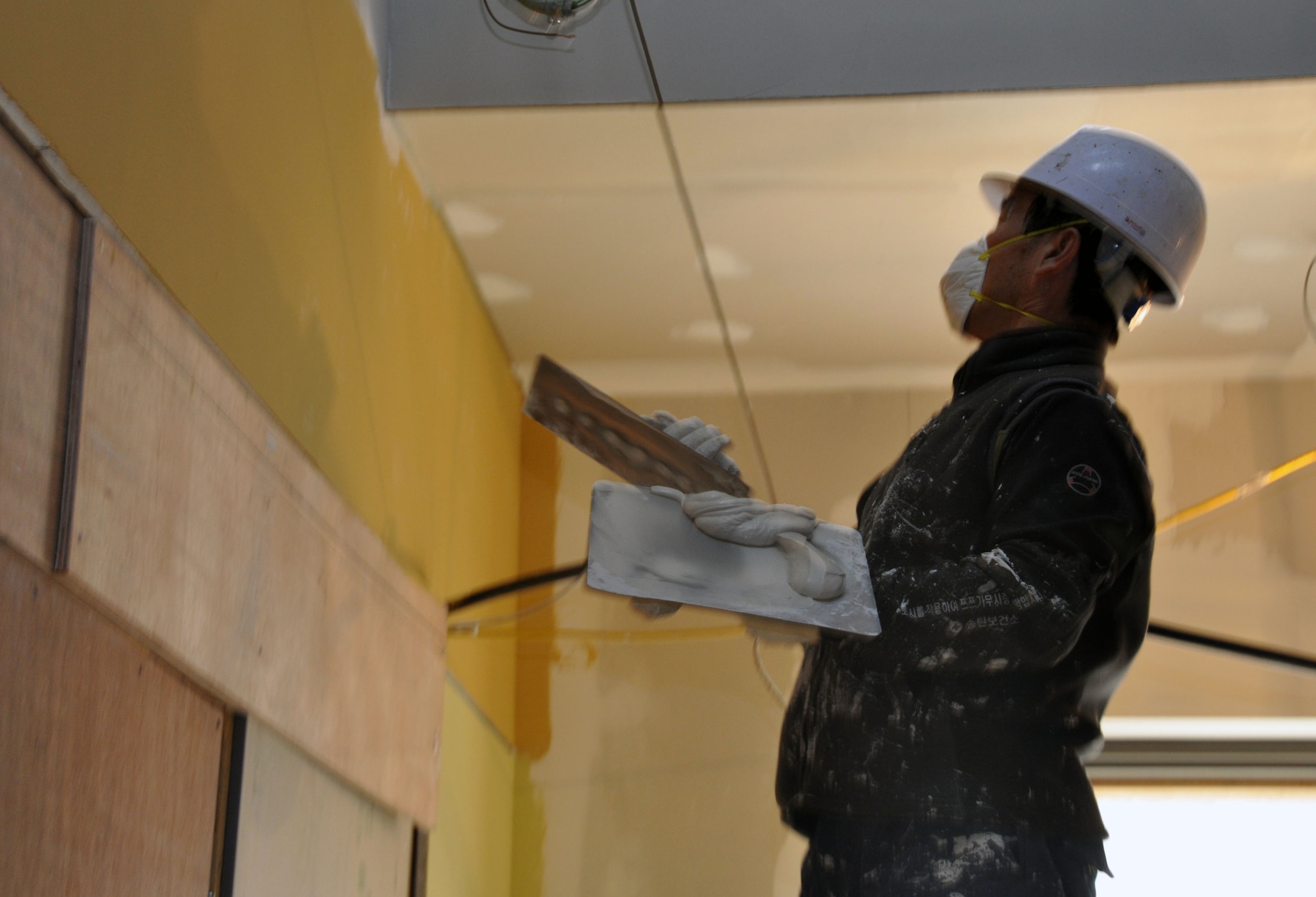 A contractor working with the 51st Civil Engineer Squadron plasters a ceiling in the newly built enlisted club, Jan. 11, 2012, at Osan Air Base, South Korea. (U.S. Air Force photo/Airman 1st Class Michael Battles) 
