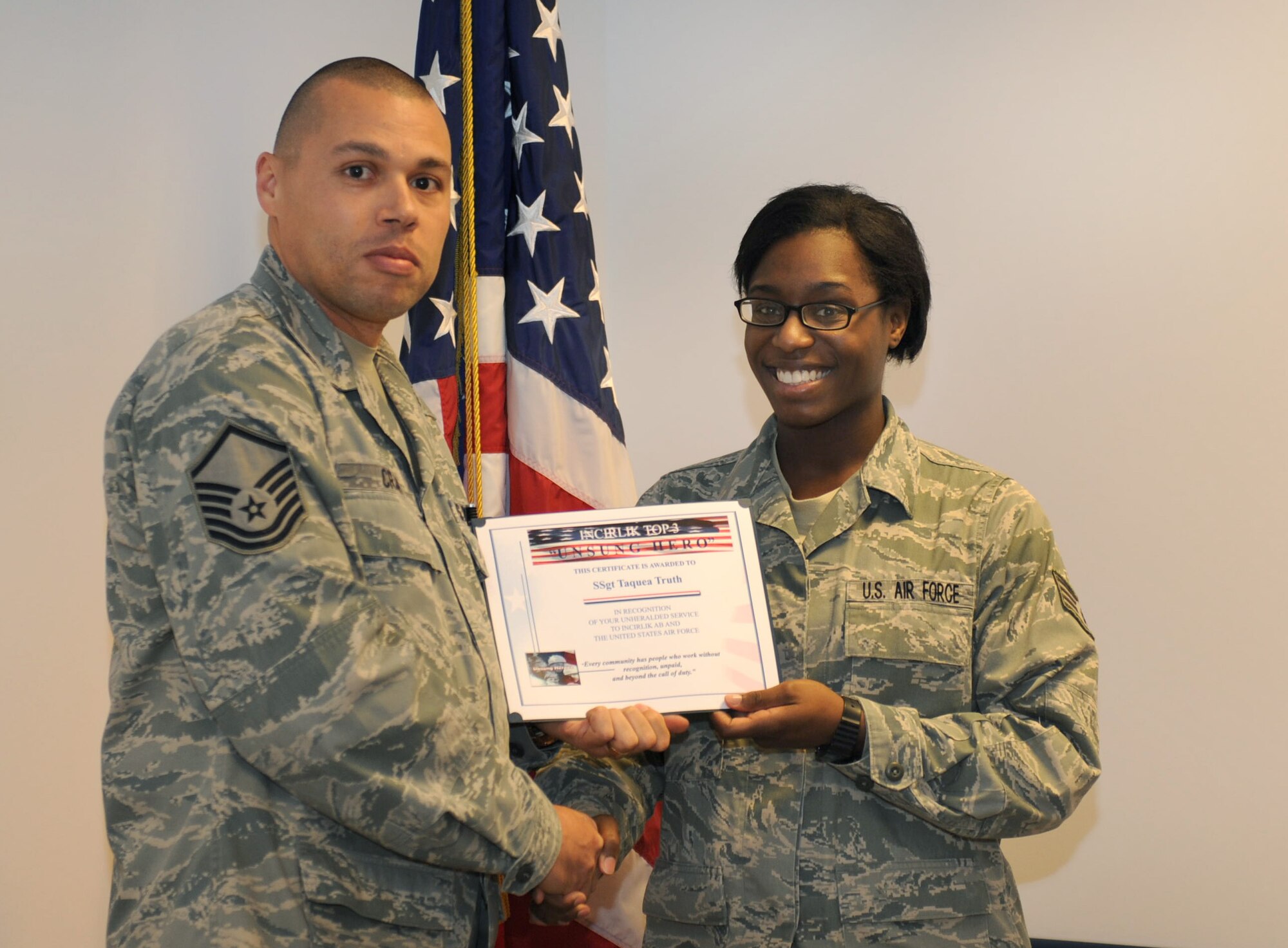 Staff Sgt. Taquea Truth, 39th Communications Squadron, receives the Unsung Hero Award from the Incirlik Top 3 organization, Jan. 19, 2012, at Incirlik Air Base, Turkey. The Top 3 presents this award monthly to Airmen who demonstrate superior job performance and exceptional leadership. (U.S. Air Force photo by Senior Airman Anthony Sanchelli/Released)