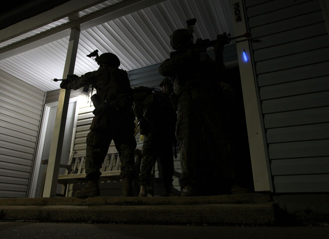 Marines with the 24th Marine Expeditionary Unit's Force Reconnaissance Platoon secure a house during a simulated night raid at a Virginia Beach police training facility here Jan.17, 2012. The Recon Marines executed the raid with Security Platoon, Battalion Landing Team 1st Battalion, 2nd Marine Regiment, 24th MEU, as part of the 24th MEU's Realistic Urban Training (RUT) exercise scheduled Jan. 5-20, which focuses on conducting off-base missions near the towns of Farmville and Creeds to prepare for the various operations they may conduct while deployed.