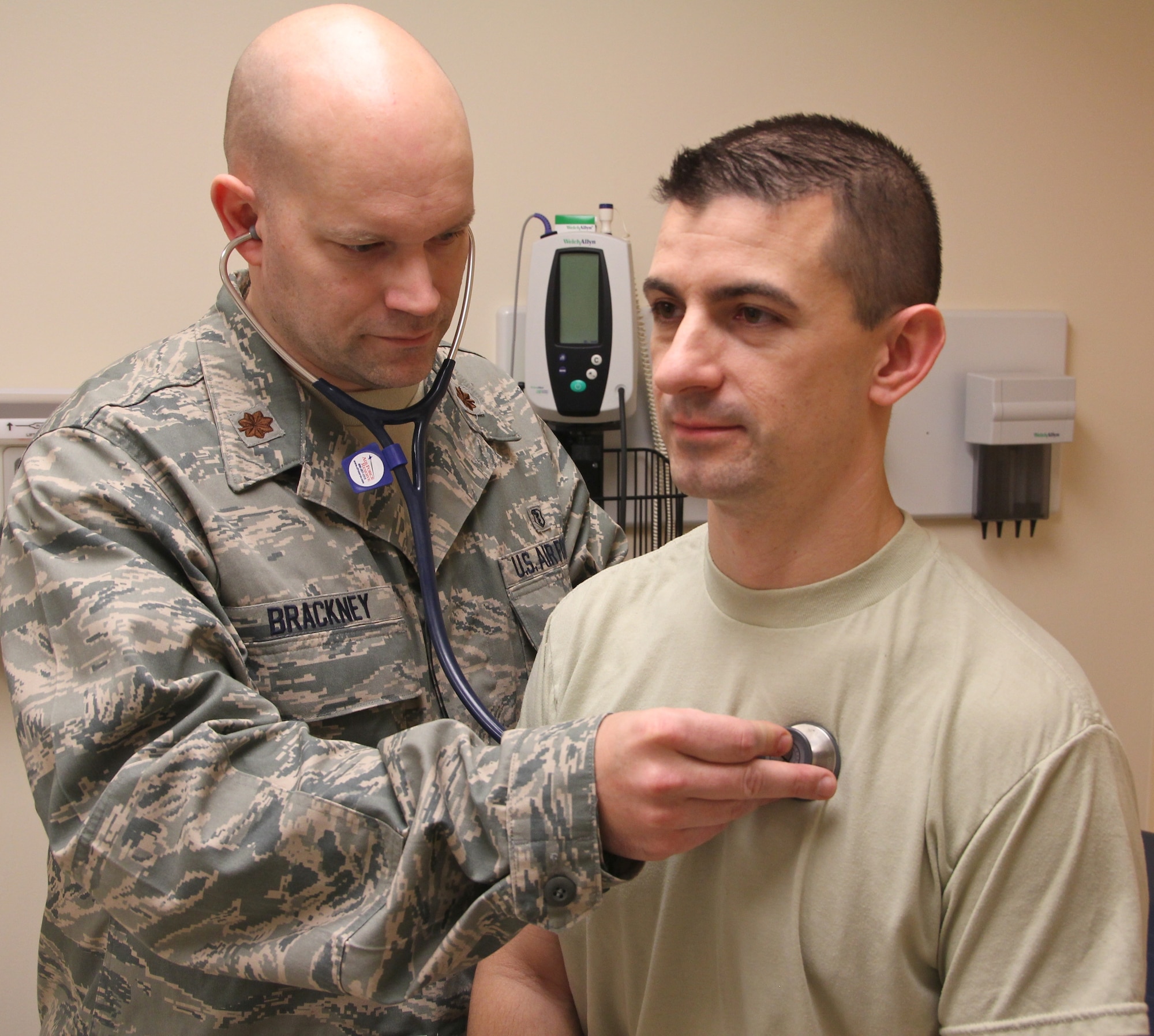 Maj. (Dr.) Chris Brackney checks the vital signs of Maj. (Dr.) Josh Valtos during a routine physical at the Scott Air Force Base Clinic. Brackney is an Air Force Reserve doctor assigned to the 932nd Aeromedical Staging Squadron.  Valtos is a member of the 932nd Aerospace Medicine Squadron.   When not in drill status or performing annual tour, Brackney is a critical care doctor and Valtos is a cardiologist in their civilian careers.  (U.S. Air Force photo/Tech. Sgt. Dan Oliver)