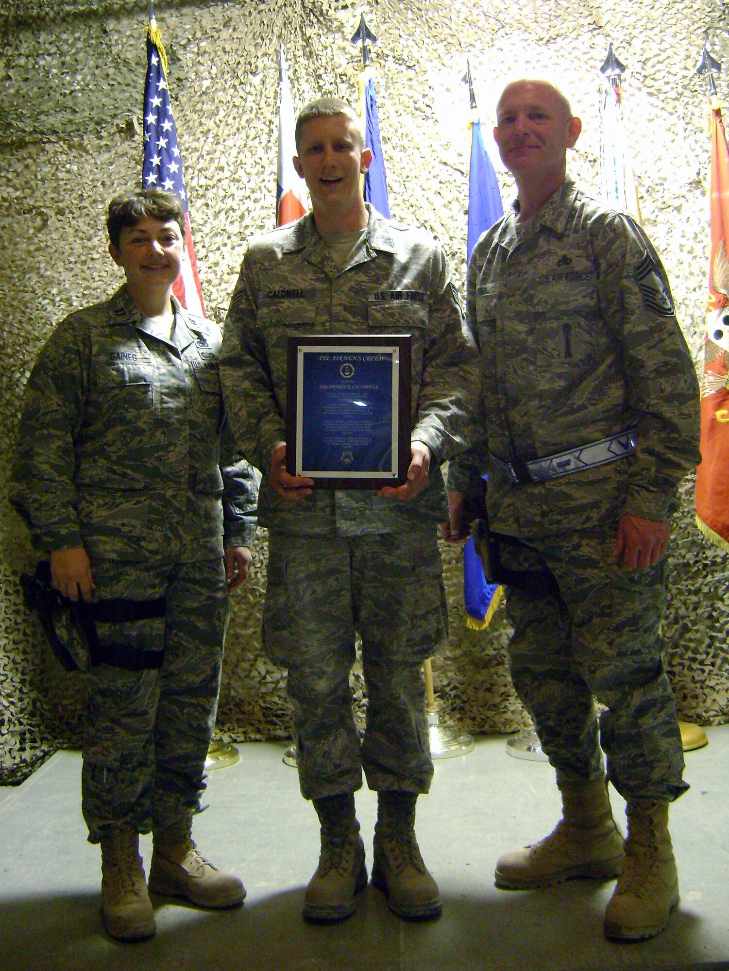 Capt. Lisa Gaines, maintenance officer; Staff Sgt. Derrick Caldwell, munitions technician; and Chief Master Sgt. Darold Fish, munitions flight superintendent; attend a joint services noncommissioned officer induction where Caldwell was inducted to the NCO Corps. Gaines, Caldwell and Fish are currently assigned to the 451st Expeditionary Maintenance Squadron at Kandahar Airfield, Afghanistan, while deployed. When home, they are assigned to the 442nd Maintenance Squadron, part of the 442nd Fighter Wing, an A-10 Thunderbolt II Air Force Reserve unit at Whiteman Air Force Base, Mo. (U.S. Air Force photo/courtesy photo)